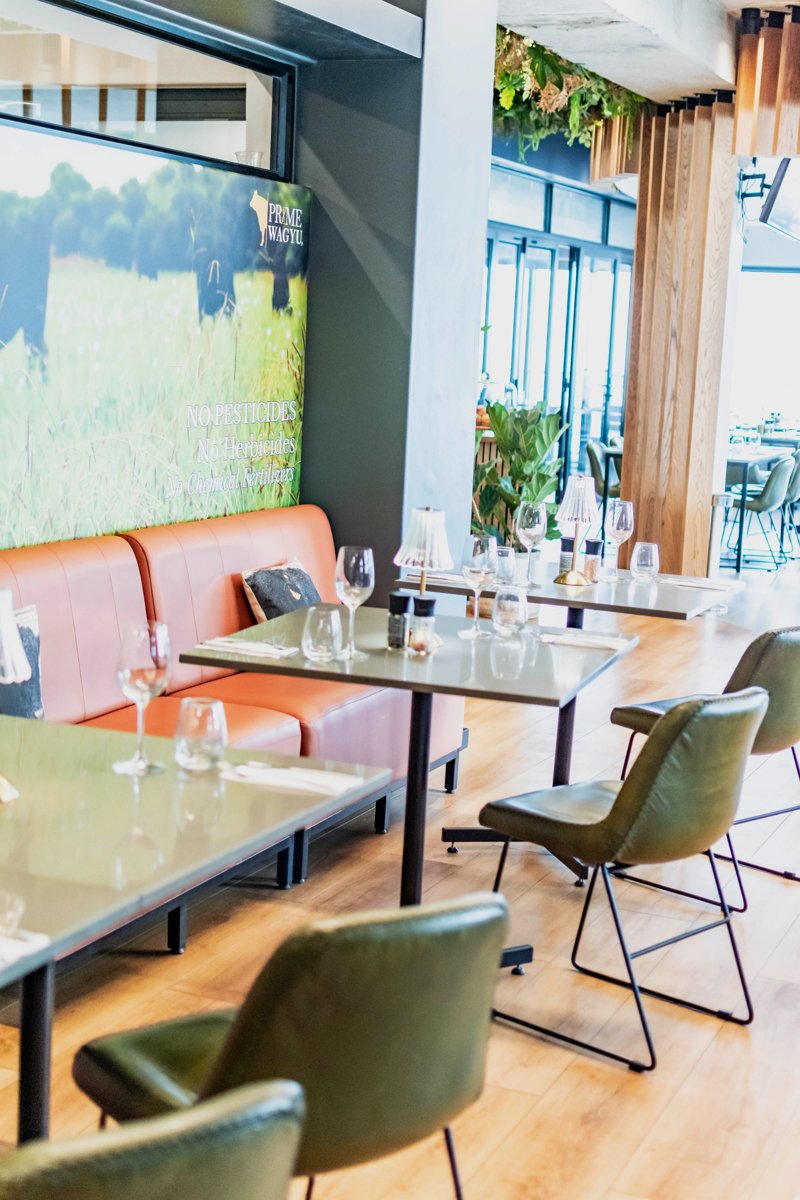 Booth seating and tables beside the restaurant windows