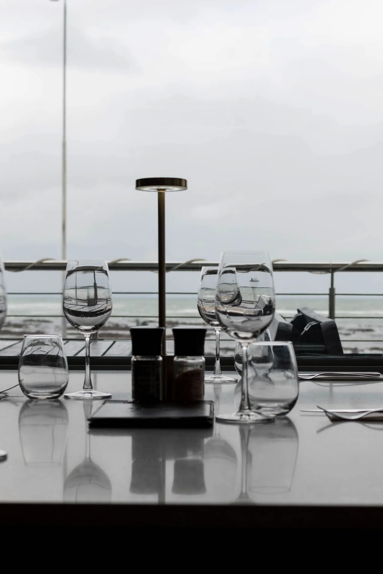 Wine glasses set at a table overlooking Strand beach at Prime Wagyu