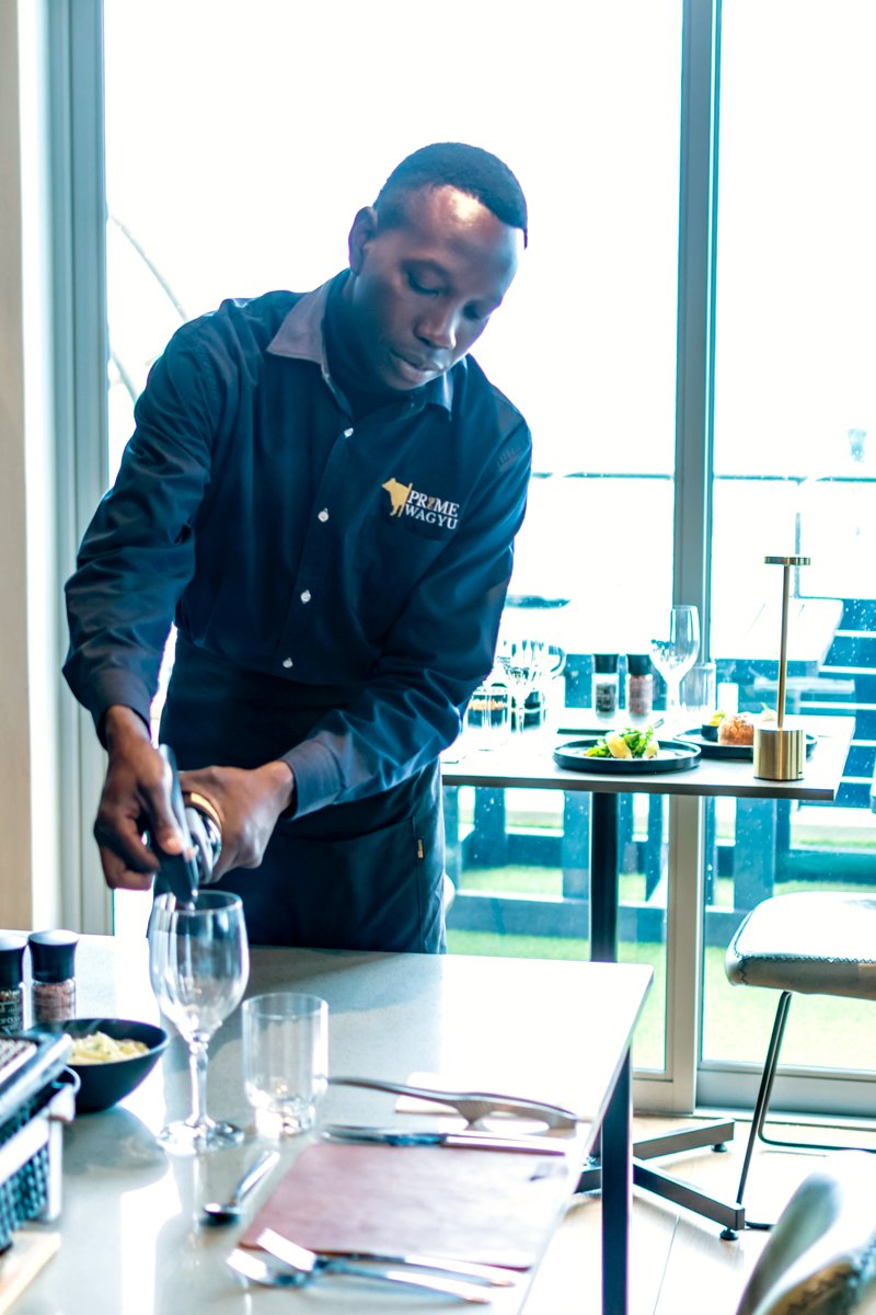 A member of the Prime Wagyu team setting a table